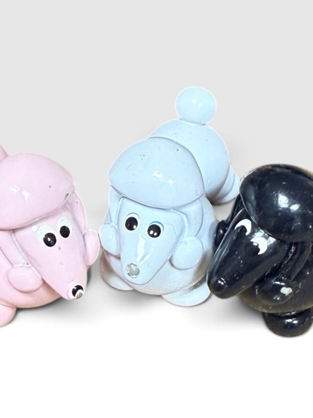 3 pieces of ceramic poodles. Pink, white and black